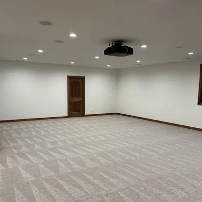 Spotless finished commercial basement space with freshly cleaned carpet and walls
