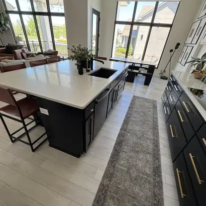 Bright, immaculately cleaned open-concept kitchen and living space by Sweeping Beauty